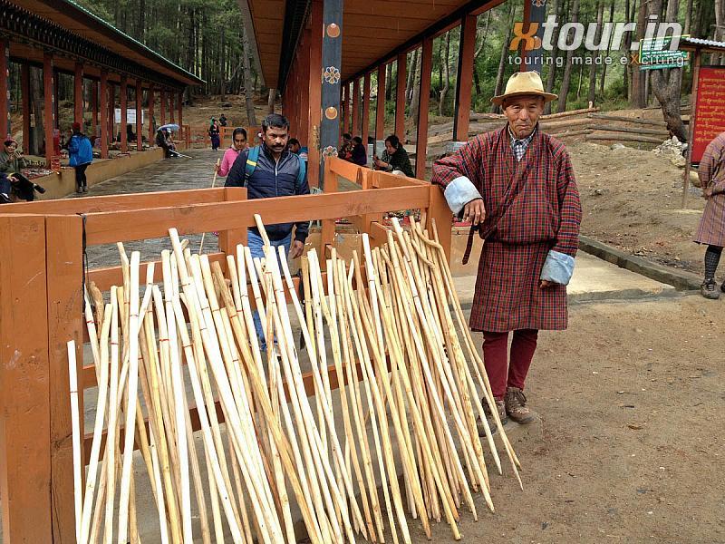 Man Selling Sticks to climb Tigers Nest Taksang at Paro Bhutan