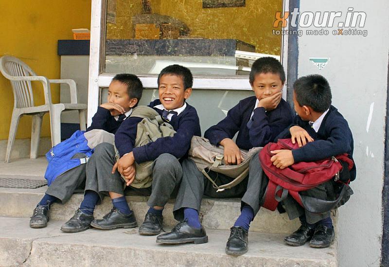 School Kids sitting outside a Shop