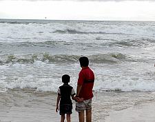 Father child looking waves at Calangute Beach