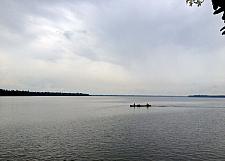 Fisherman Boat in Kumbalam Lake with monsoon clouds in sky